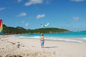 child-on-st-jean-beach-watching-plane